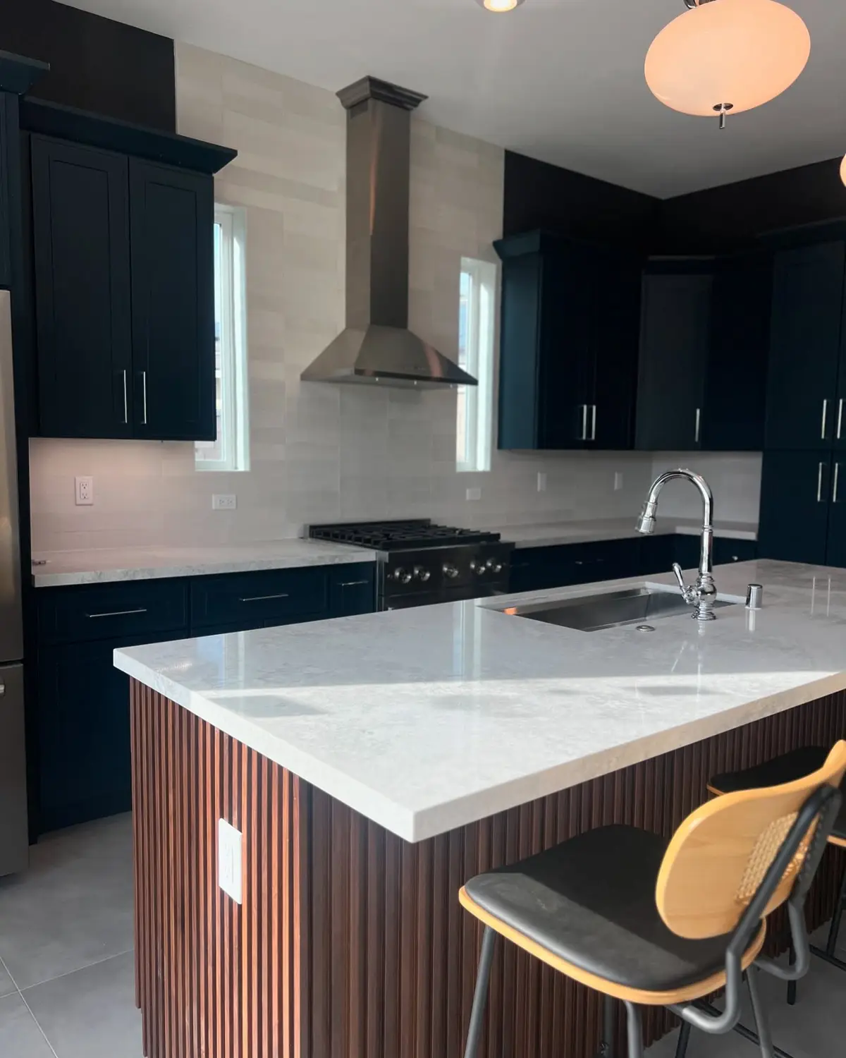 ADU kitchen with dark cabinets and a quartz island