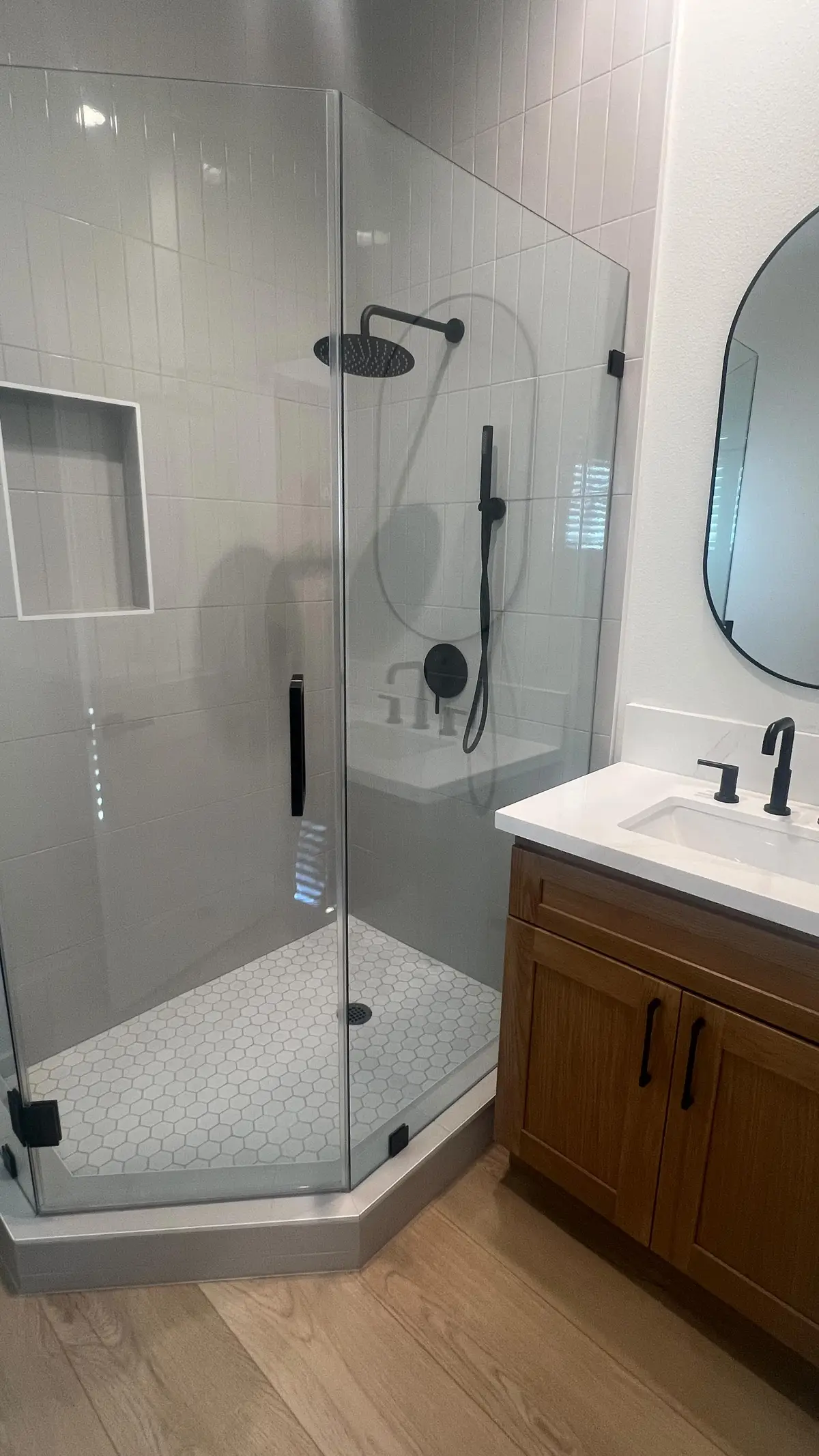 800 sq ft detached ADU in Riverside, CA: adu bathroom with a glass corner shower and black fixtures