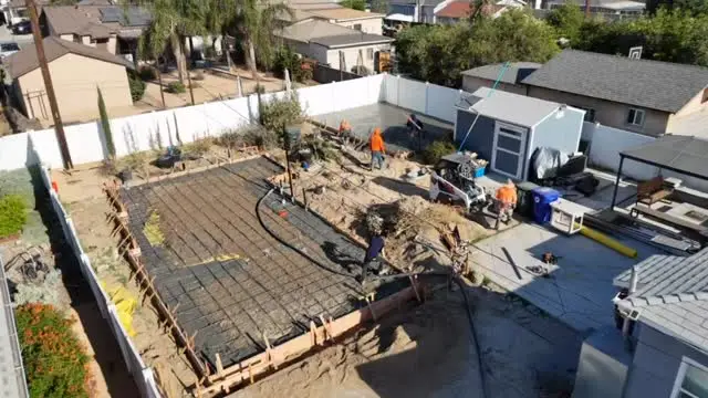 Crew pouring a concrete slab for a backyard ADU