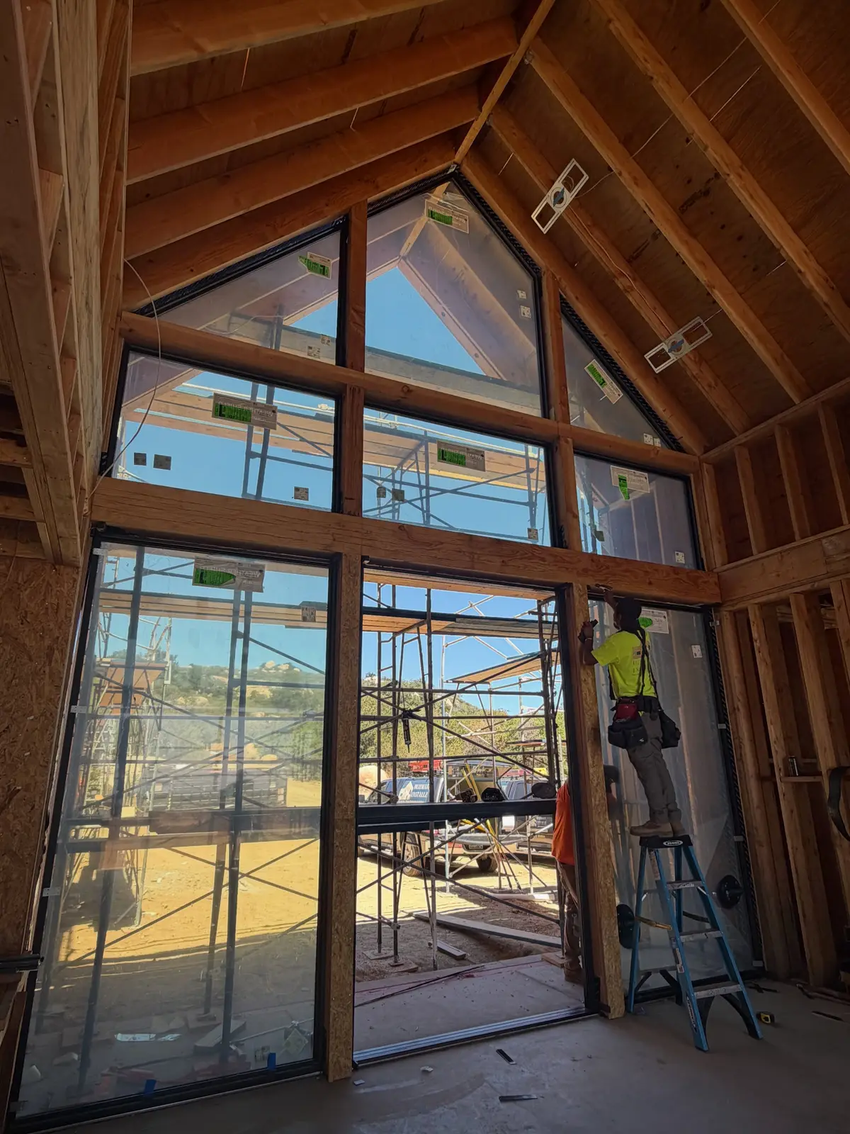 10,308 sq ft modern custom home in Riverside, CA: vaulted framing with angled window walls during construction