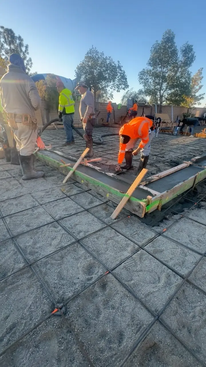 Crew placing concrete over rebar on pour day, by J.O. Construction, licensed contractor in chino, CA
