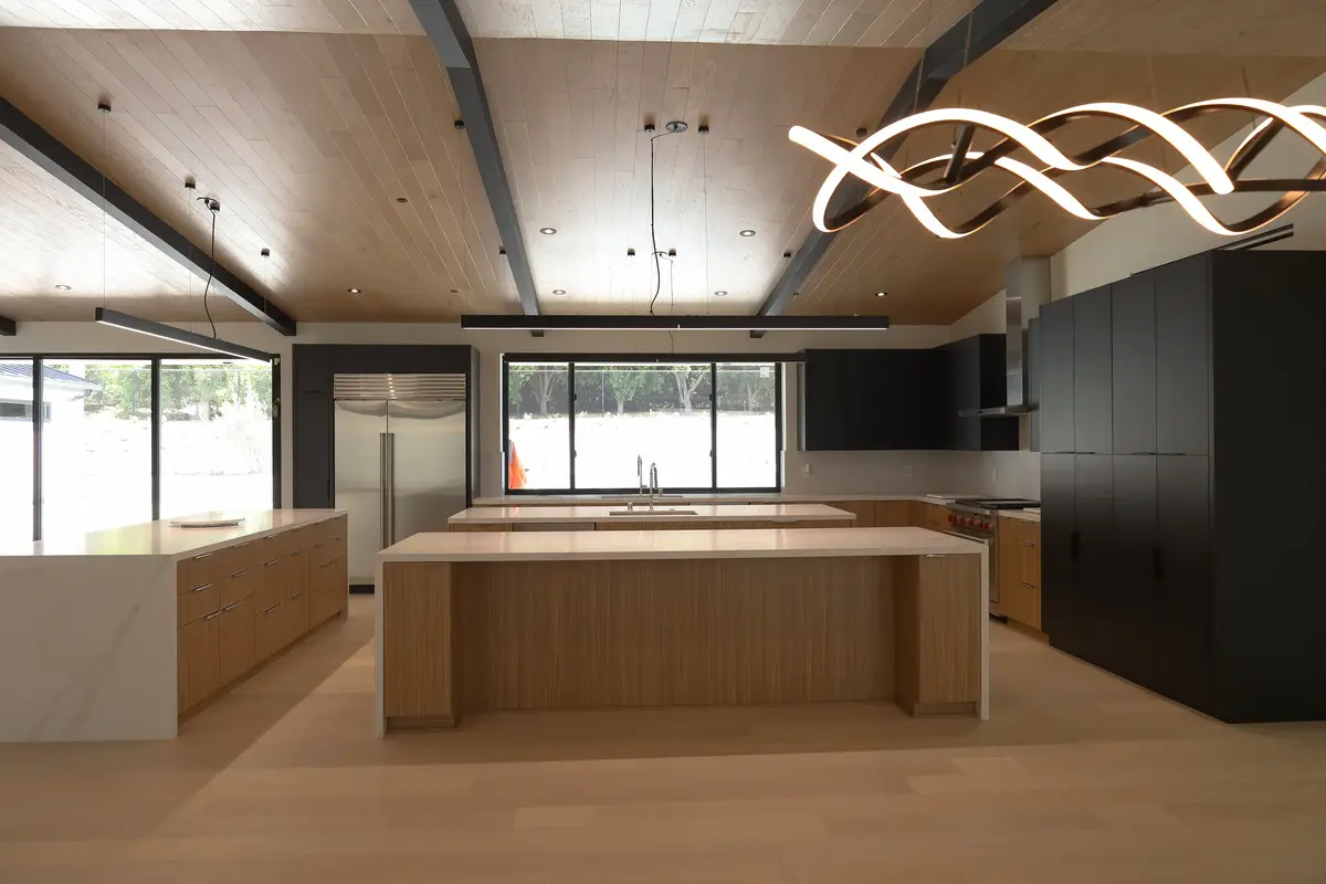 Large custom kitchen with a wood ceiling and long island, built by J.O. Construction
