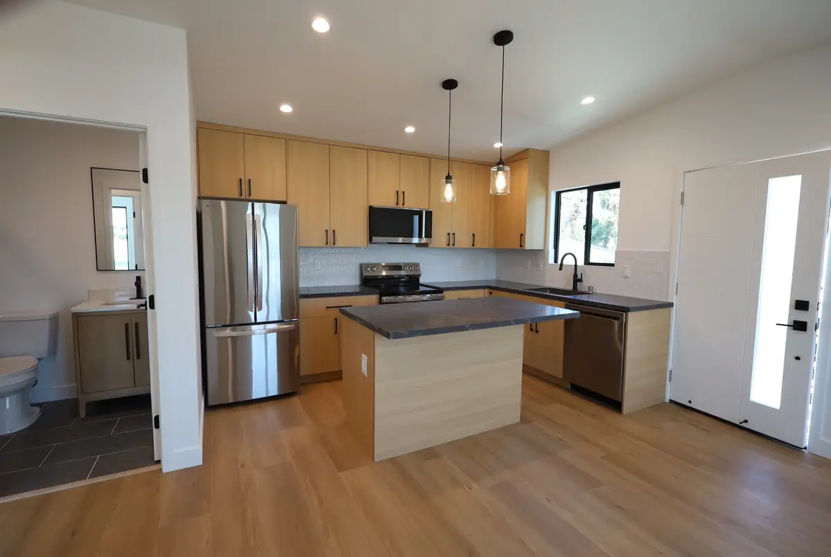 Duplex ADU in San Clemente, CA: new adu kitchen with light wood cabinets and an island
