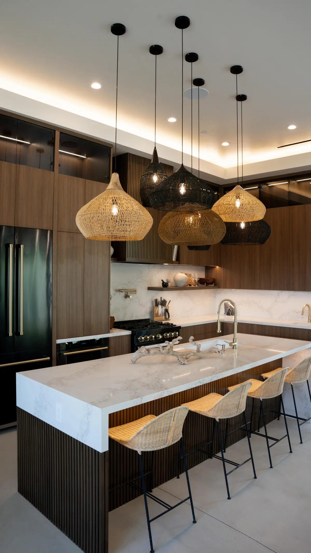 Kitchen with a waterfall island, bar stools and pendant lights