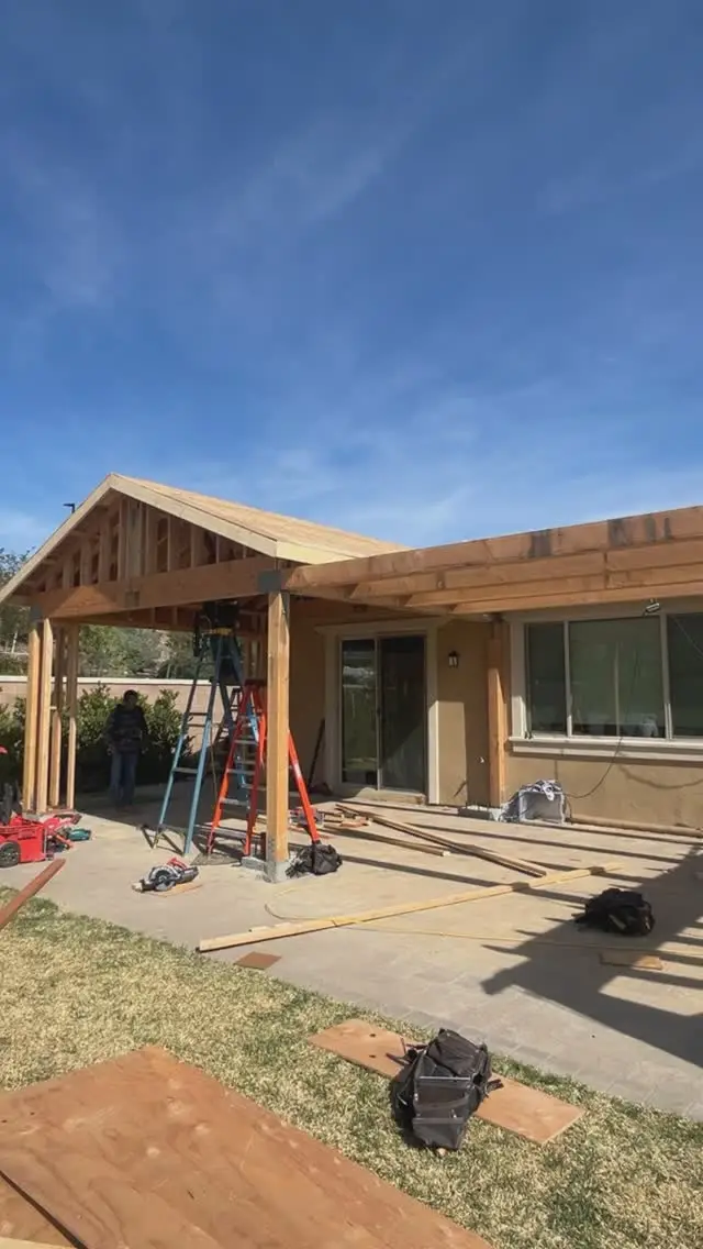 Two patio sections with a pergola in Fontana, CA: patio addition framed off the back of a house
