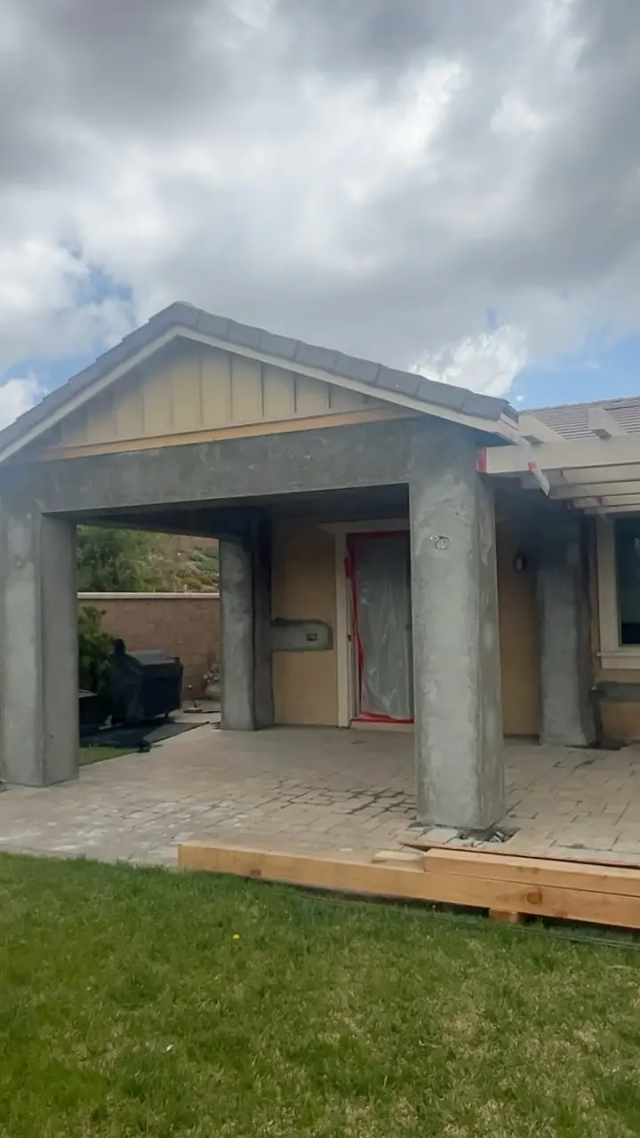 Two patio sections with a pergola in Fontana, CA: patio cover addition with columns before final finish