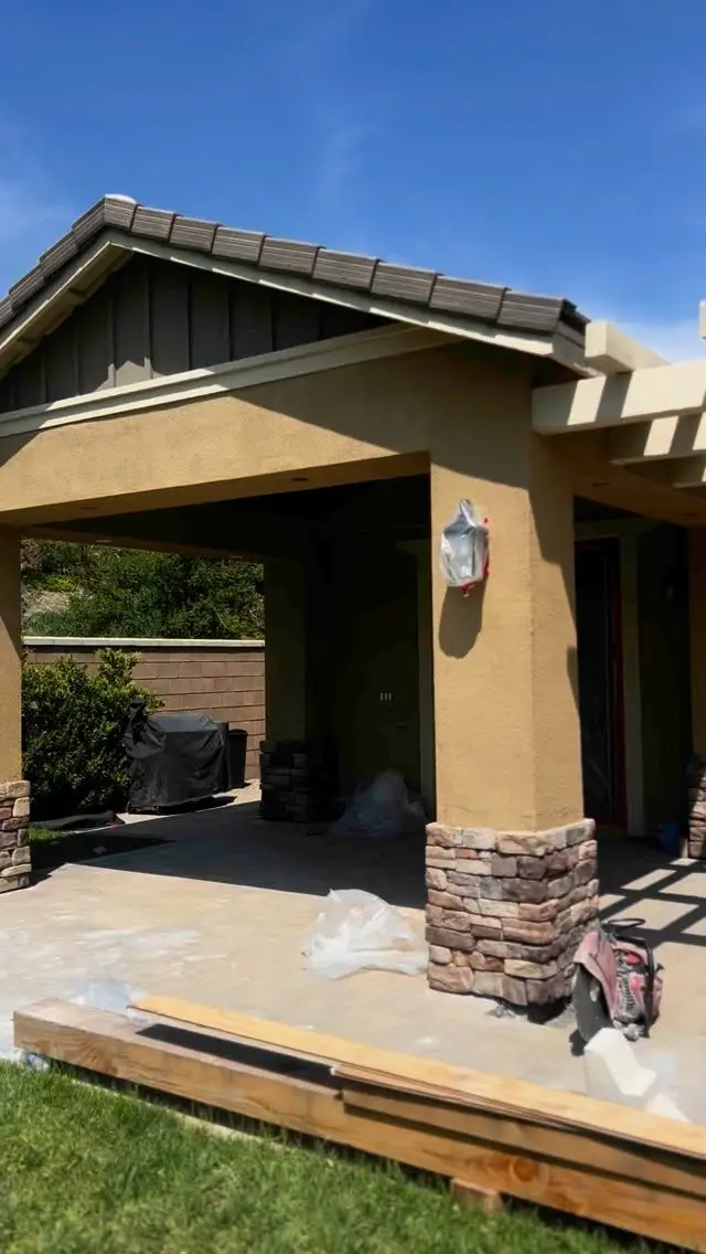 Stucco patio cover addition with stone column bases